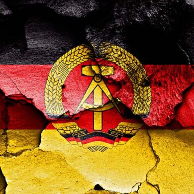 flag of east germany painted on cracked wall
